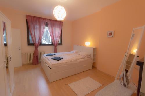 a small bedroom with a bed and a window at Central Charming Home with Garden near Parking and NDK in Sofia