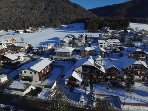 an aerial view of a town with snow covered roofs at Garni Renzler in Rasun di Sopra
