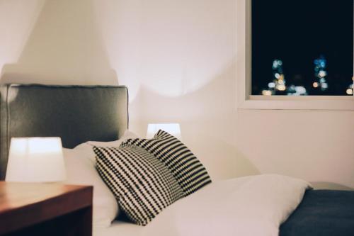 a bedroom with a bed with a pillow and a window at GONGGAN Residence Hotel in Geoje 