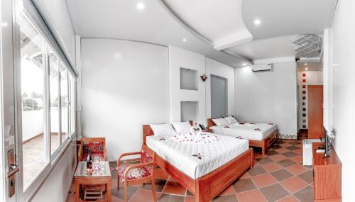 Postelja oz. postelje v sobi nastanitve Le Huynh Mui Ne Hotel