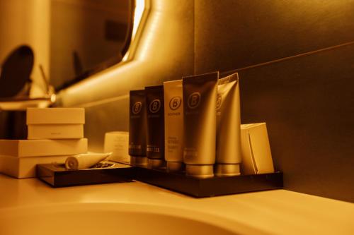 a pile of toiletries on top of a bathroom sink at Jurmala Golf Club&Hotel in Piņķi