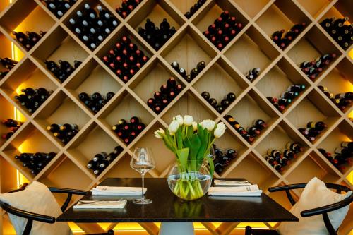 a dining room with a wall of wine bottles at Jurmala Golf Club&Hotel in Piņķi