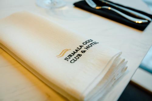 a white napkin with a fork on top of it at Jurmala Golf Club&Hotel in Piņķi
