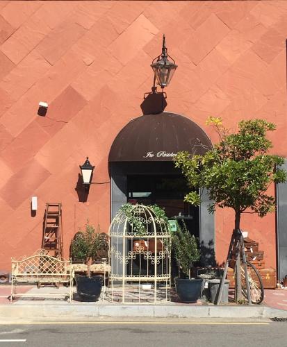 a store front with a black awning and plants in a window at GONGGAN Residence Hotel in Geoje 
