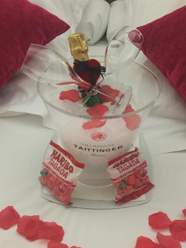 a glass vase with a bottle of lipstick in it at Hôtel Saphir Lyon in Lyon