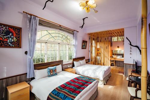 仁愛鄉的住宿－清境雲南風情景觀山莊，一间卧室设有两张床和窗户。