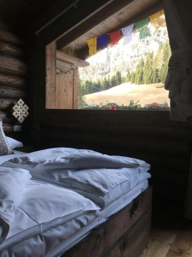 A bed or beds in a room at Alpin Park Sappada Village