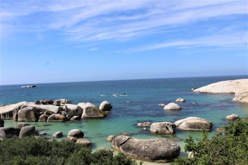 a large group of rocks in the water at South Peninsula Beach Apartment in Cape Town