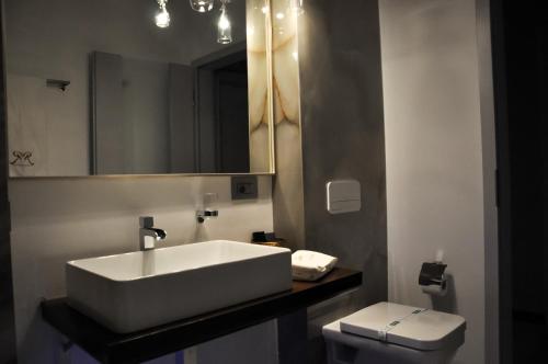 a bathroom with a white sink and a toilet at Rubio Residence - Accmonia Luxury Apartment in Arad
