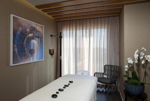 a hospital room with a bed and a window at Cramim by Isrotel Exclusive in Qiryat ‘Anavim