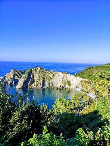 a view of a small island in the ocean at Hotel Restaurante el Fornon in Novellana