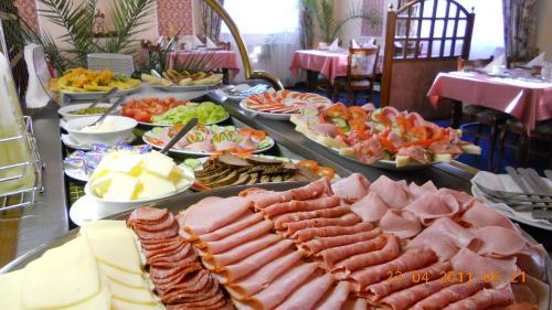 a buffet with many different types of meats and cheese at Eurohotel in Karlovy Vary