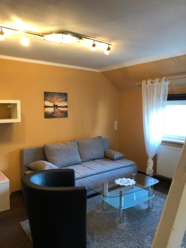 a living room with a couch and a table at Hotel-Restaurant Gasthof zum Schützen in Baiersbronn