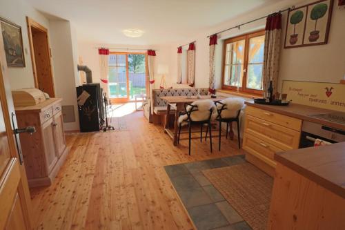 a kitchen and living room with a table and chairs at Chalet Heidi in Bad Kleinkirchheim