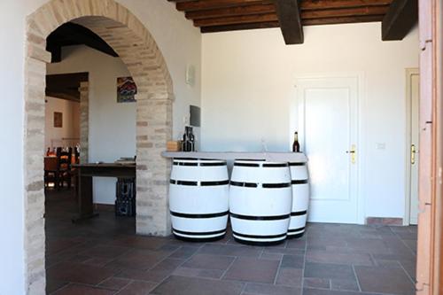 a kitchen with a counter and a table in a room at Casale Rialto in Montefalco