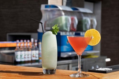 two cocktails sitting on a table with a drink at Royal Beach Hotel Tel Aviv by Isrotel Exclusive in Tel Aviv