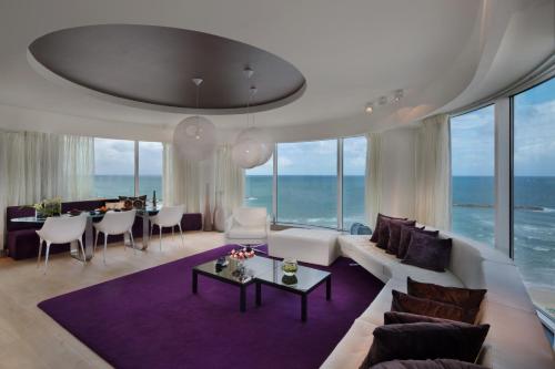 a living room with a couch and a table at Royal Beach Hotel Tel Aviv by Isrotel Exclusive in Tel Aviv
