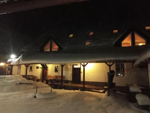 a house covered in snow at night at Penzion U dvojice in Nové Město na Moravě