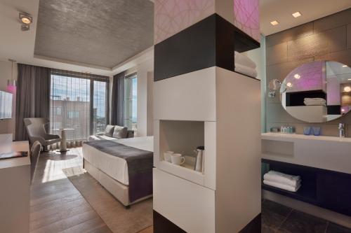 a hotel room with a bed and a living room at Royal Beach Hotel Tel Aviv by Isrotel Exclusive in Tel Aviv