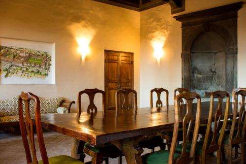 a dining room with a wooden table and chairs at Certosa di Pontignano Residenza d'Epoca - Place of Charme in Ponte A Bozzone
