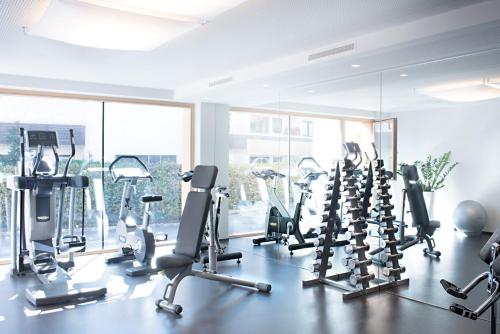 a gym with rows of treadmills and elliptical machines at Hapimag Ferienwohnungen Zell am See in Zell am See