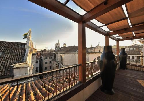 a balcony with a view of a city with vases at Al Theatro Palace in Venice