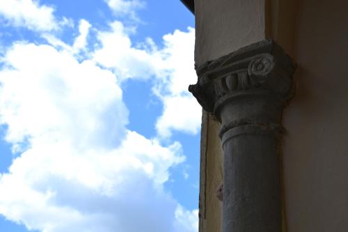 a pillar of a building with a cloudy sky in the background at Certosa di Pontignano Residenza d'Epoca - Place of Charme in Ponte A Bozzone