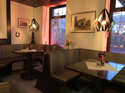 a restaurant with two tables and a couch and chairs at Haus Bergmann in Harsewinkel