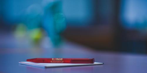 a red pen sitting on top of a table at Hotel Alexandra in Wels