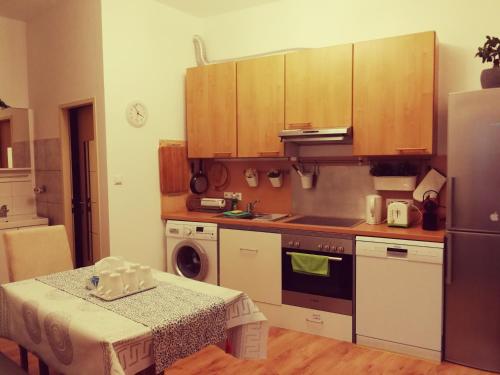 una pequeña cocina con mesa y nevera en Jungle Apartment Vienna Self check-in, en Viena