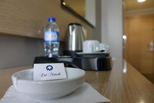 a bowl on a table with a sign on it at Otel Mutevelli in Kastamonu