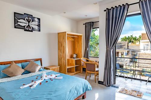 a bedroom with a bed and a balcony at Little Boss Homestay in Hoi An