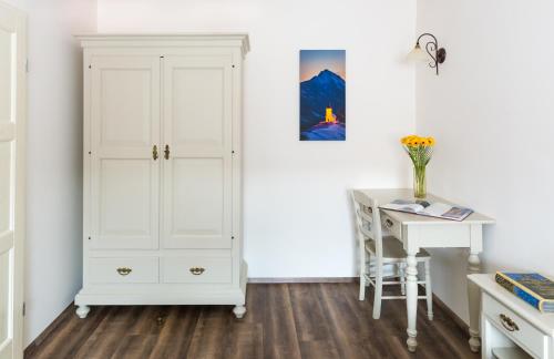 a bedroom with a white closet and a desk at Barbo Palace Apartments and Rooms in Ljubljana