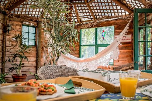 a room with a table with food and a hammock at Peppercorns B&B in McLaren Vale