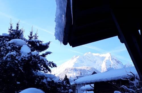 a view of a snow covered mountain from a window at Landhaus zum Griena in Mayrhofen