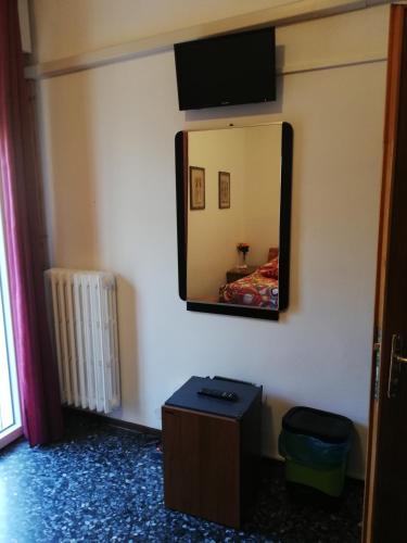 a mirror on a wall with a bed in a room at Venice Best Vacation in Marghera