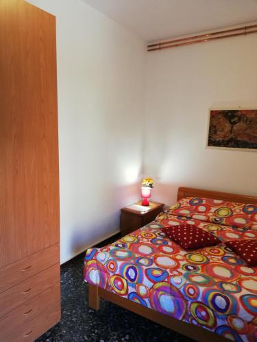 a bedroom with a bed with a colorful comforter at Venice Best Vacation in Marghera