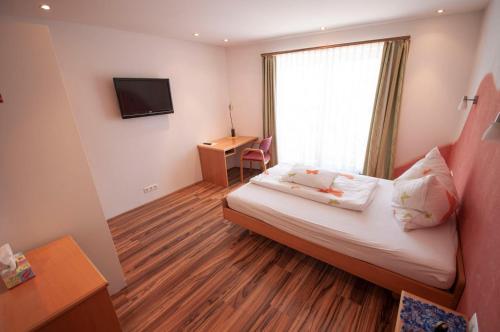 une chambre d'hôtel avec un lit et une fenêtre dans l'établissement Gasthof Winkelwirt, à Althofen