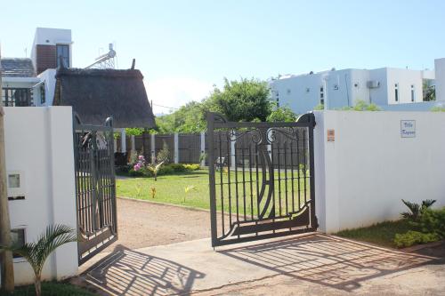 an open gate to a yard with a house at Villa Kayana in Flic-en-Flac