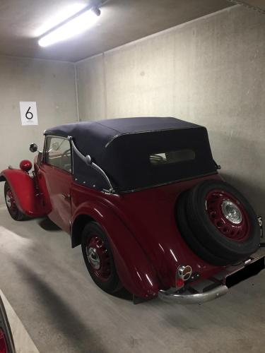 an old red car is parked in a garage at Hotel Moselauen in Bernkastel-Kues