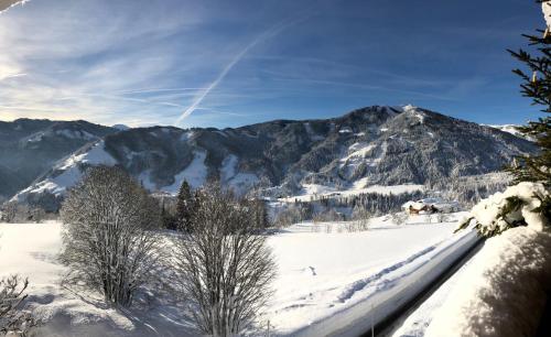 a snow covered mountain with mountains in the background at Sonnhof am Hochkönig in Mühlbach am Hochkönig