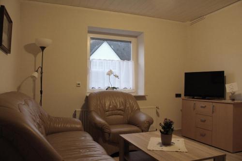 a living room with a couch and a chair and a window at Gollnow in Soltau