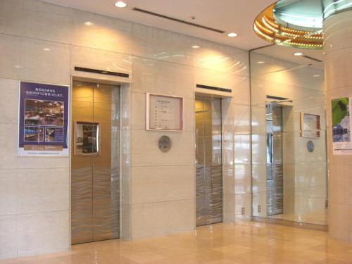 a lobby with three elevators in a building at Kagoshima Washington Hotel Plaza in Kagoshima