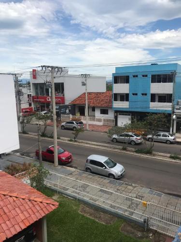 a street with cars parked on the side of a road at TRES TORRES POUSADA in Torres