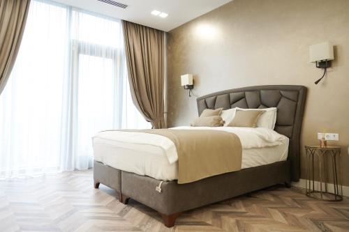 1 dormitorio con 1 cama grande con almohadas blancas en Apartment Tbilisi in King David, en Tiflis