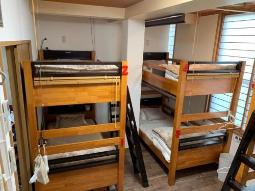 two sets of bunk beds in a room at Nono teru Narita in Narita