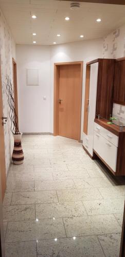 an empty room with a door and a tile floor at Nettes 2- Zimmer Apartment in Sehnde