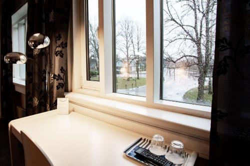 a window with a keyboard on a table in front of it at Hotel CityHovi in Rauma