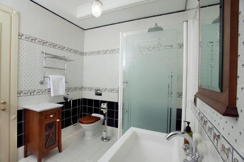 a bathroom with a tub and a toilet and a sink at Bortnichi House in Kyiv