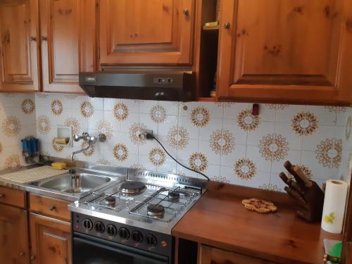 a kitchen with a stove and a sink at Appartamento Limone con vista in Limone Piemonte